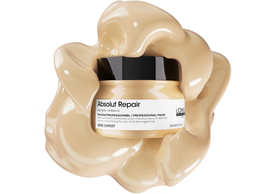 Fotografia da embalagem da máscara capilar L’Oréal Professionnel Absolut Repair sobre um fundo texturizado, realçando a sua textura rica e cremosa para cabelos danificados.